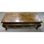 Mirror veneered and cross banded walnut coffee table of Chinese style with a shaped apron and on