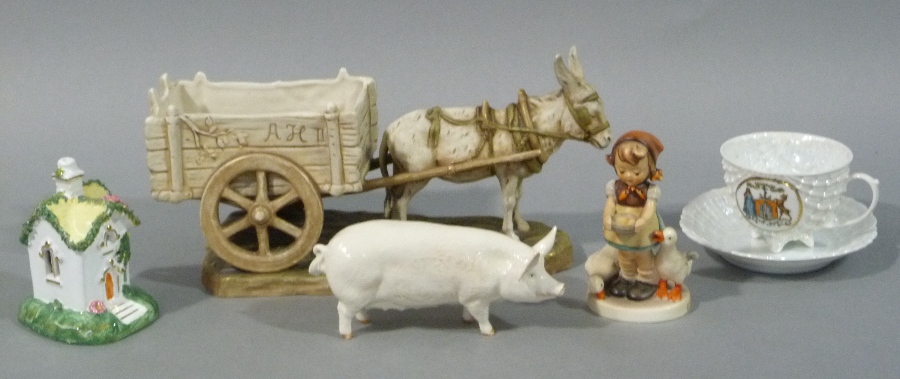 A Royal Dux figure group of a donkey harnessed to a cart, rustic base,