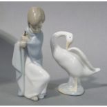 A Lladro figure of a young girl seated with an umbrella (lacking),