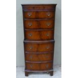 A reproduction mahogany finish chest on chest of six graduated drawers on shaped bracket feet