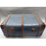 A blue painted canvas and wooden ribbed trunk with brass lock plates