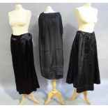 An Edwardian black satin day skirt with button detail together with a black silk skirt with beaded