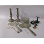 A pair of pewter candlesticks on circular bases, two Antimony backed hand mirrors and a box, ebony