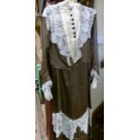 A Victorian brown silk two piece gown c.1890, having a cream lace inset with further lace shawl