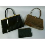 A brown crocodile skin handbag with single strap gilt metal frame, pale suede interior, faux