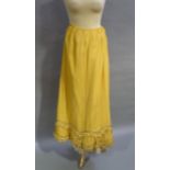 A late Victorian full length yellow crepe skirt the two tier scalloped hem detailed with trim and