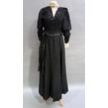 A Victorian black dress having a lace inset and collar with black sequin and beaded detail puffed