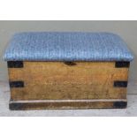 A pine and metal bound lodging box with scumbled paint effect and upholstered top