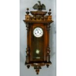 A 19th century mahogany Vienna wall clock with carved eagle pediment