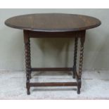 A small oak oval drop leaf table on barley twist and square framing