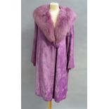 A lady's purple faux fur coat with long haired faux fur shawl collar and button tie c.1959