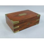 A George IV brass bound figured mahogany dressing table box, the hinged lid with recessed brass