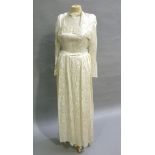 A 1940s ivory satin wedding gown with a paisley style self coloured print with square neckline and