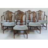 A set of eight Hepplewhite style dining chairs each having an arched back with pierced splat and