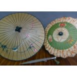 Two Chinese parasols and a vintage umbrella