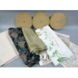 A box of various fabric lengths, together with three rolls of webbing for upholstery