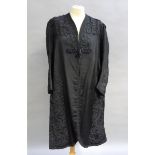 A late Victorian/Edwardian black ribbed fabric coat with applied braided decoration
