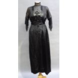 An Edwardian black silk and lace gown having a cream silk bodice with lace and sheer black over