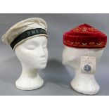 A gentleman's red velvet and embroidered smoking hat, together with a sailor's cap the ribbon