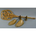 A pair of gentleman's oak shoe trees, together with a wicker carpet beater