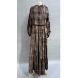 A Victorian silk black and brown checked gown having a smocked detail to the waist full sleeves with