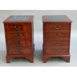 A pair of mahogany finished twin drawer filing cabinets with blue leather incised surfaces and on