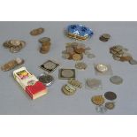 A wooden box containing a collection of decimal coins, stop watch, military badges, cigarette cards,