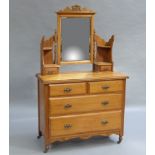 A late Victorian satin birch dressing table with central swing bevelled plate supported on a