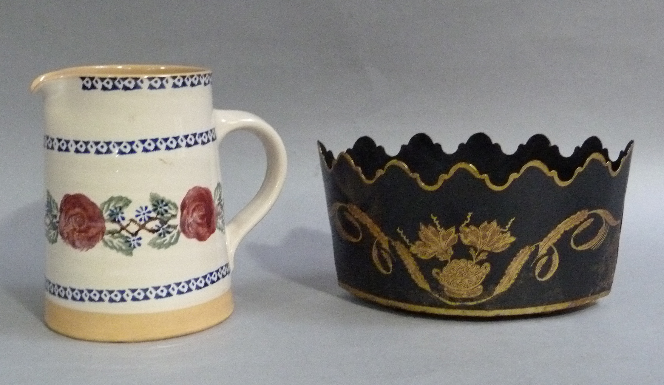 A Irish pottery jug painted and stenciled with roses between blue borders, together with a