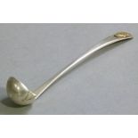 A George V silver liqueur ladle the bowl silver gilt with spout the waisted handle applied with '