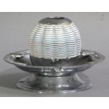 A silver match holder mounted in a chrome ashtray