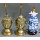 A pair of brass buddha head table lamps, 24cm high; a reproduction Chinese porcelain table lamp