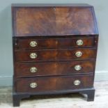 A George III mahogany bureau,the fall-flap butterfly veneered above four long graduated,