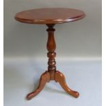 A mahogany tripod table