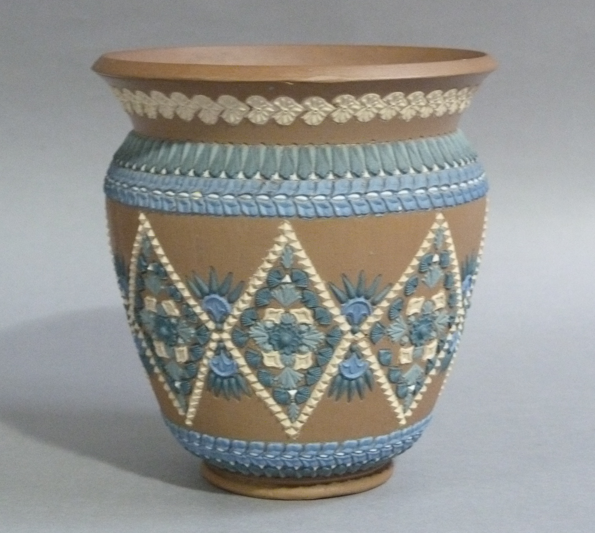 A Doulton silicone jardiniere, the buff ground applied with green, blue and ivory diamond design