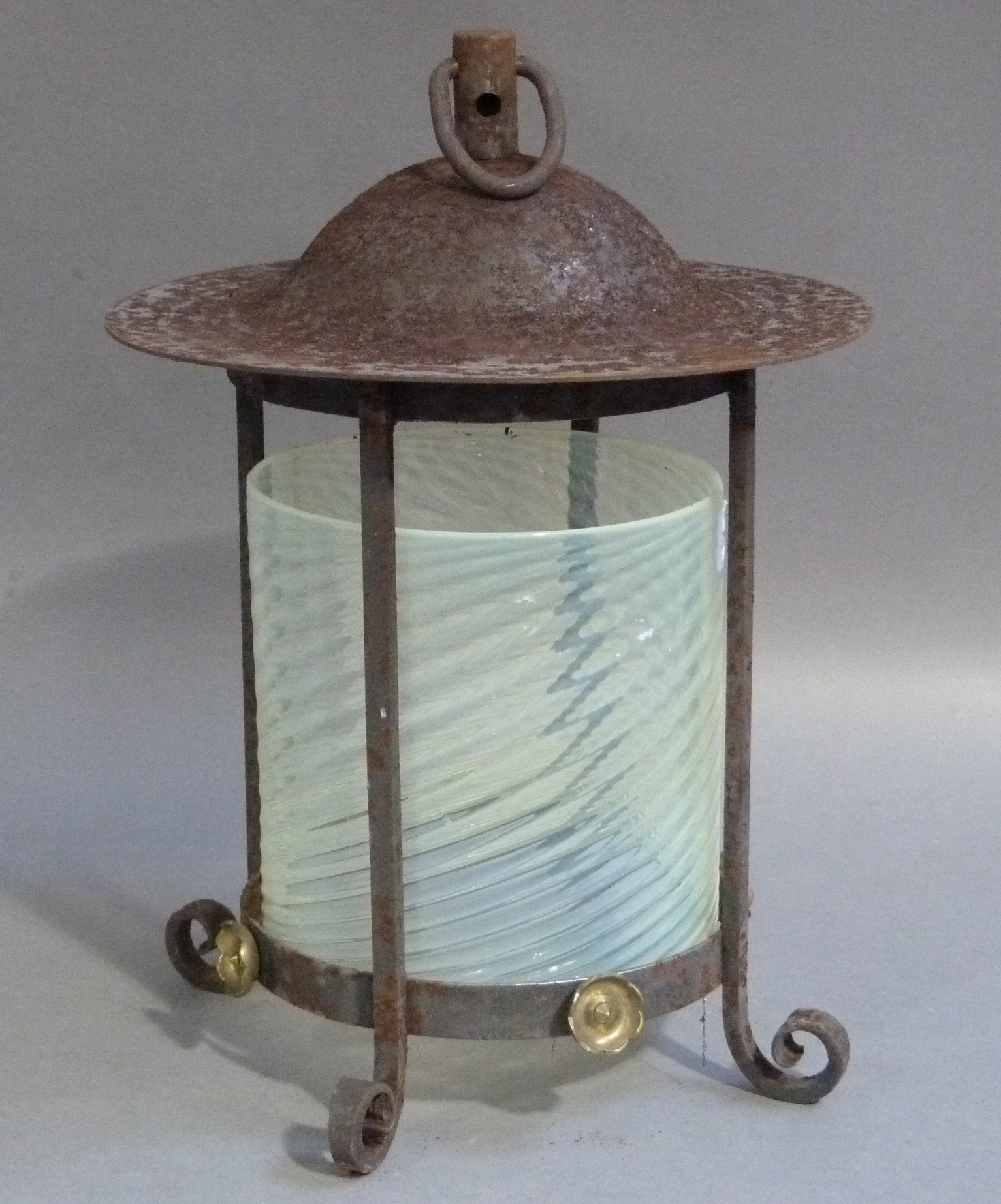 An iron framed hall lantern with suspension ring post and domed top, the quadruple posted frame with