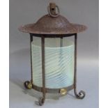 An iron framed hall lantern with suspension ring post and domed top, the quadruple posted frame with