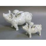 Two pottery figures of flying pigs, 31cm long and smaller