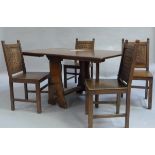 An reproduction oak drop leaf table with four oak chairs with carved backs with square framing