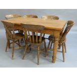 A modern dining table table on turned legs, together with a set of six dining chairs
