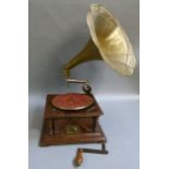 A reproduction His Masters Voice gramaphone with brass trumpet, the mahogany case with turned corner