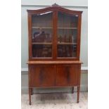 A reproduction mahogany display cabinet in George III style the serpentine shaped cavetto moulded