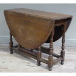 An oak drop leaf gateleg table on turned legs