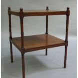 A George IV mahogany two tier whatnot the rectangular top with sphere finials to the corners on