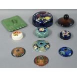 A Moorcroft Wisteria ginger jar lid 14cm diameter, two Eventide hair tidy covers in shades of blue