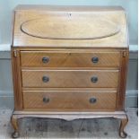 An early 20th century mahogany bureau having a full front with raised panel the interior fitted with