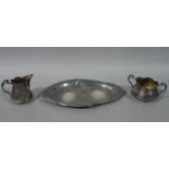 An Art Nouveau three piece silver plated sugar and cream set with tray, each piece with pierced