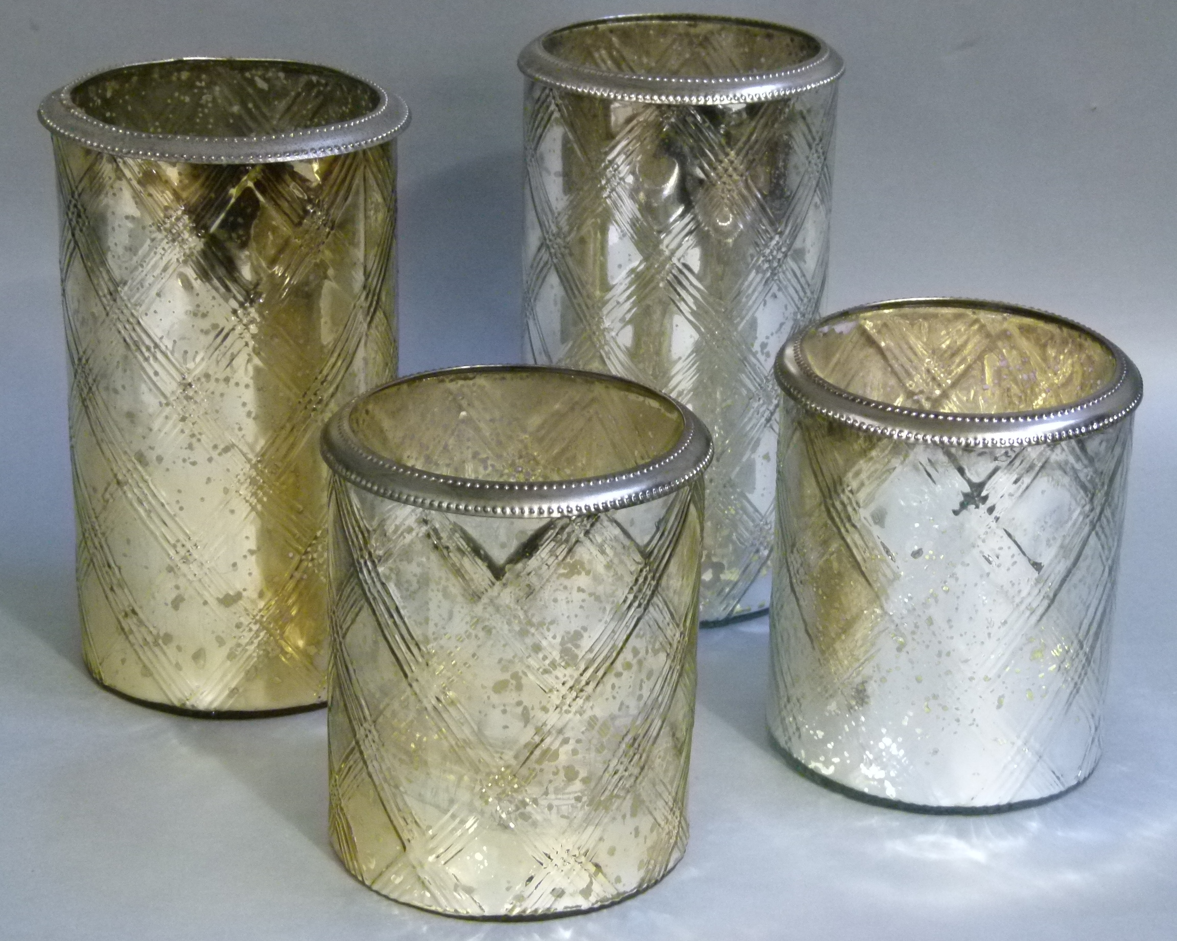 Two pairs of silvered glass vases of cylindrical form each moulded with criss cross decoration,