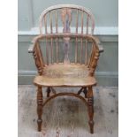 An early 19th century ash and elm low back windsor armchair having a pierced splat and rails, turned