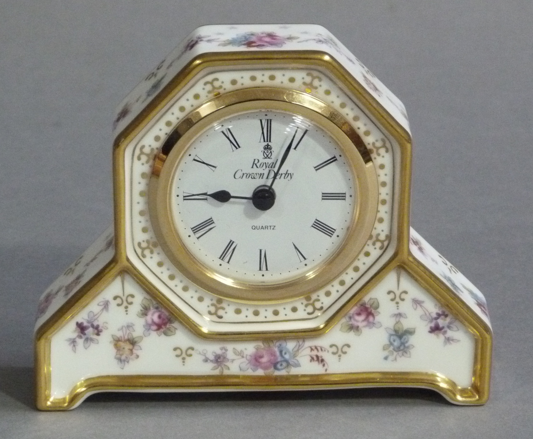 A Royal Crown Derby Antionette pattern mantel clock, the gilt metal mounted face within an octagonal